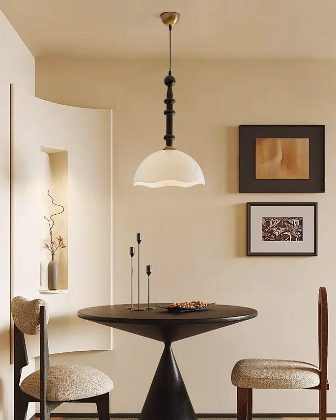 Dome pendant hanging over a dining table